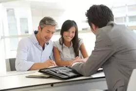 Couple Signing Mortgage Documents